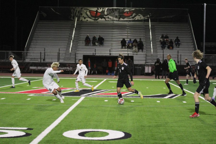 Junior midfielder no. 7 Joey Hansford dribbles the ball downfield towards The Colonys goal. Hansford has been on the soccer team for three years.
