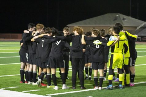 The boys soccer team huddles before a game. The leopards went 9-12-1 on the season.