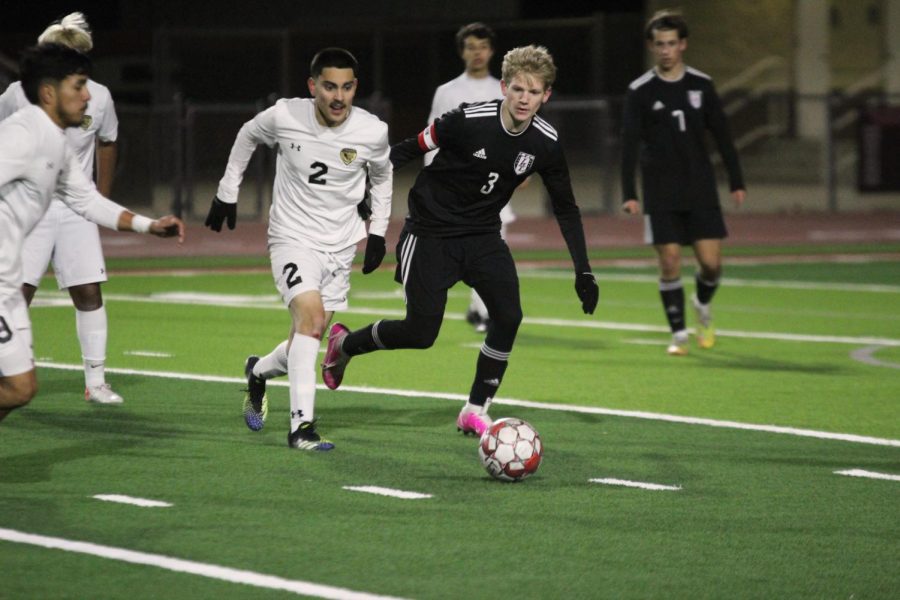 Junior forward no. 3 Caden Carlock runs to intercept the ball from The Colonys senior defender no. 2 Emilio Fuentes. The boys soccer team will play Wylie East on Friday.
