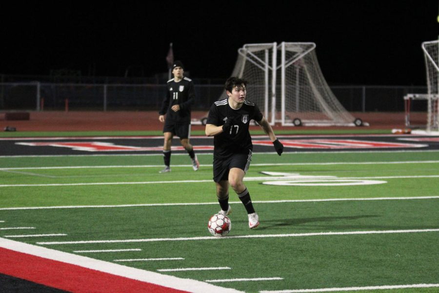 Senior midfielder no. 17 Nico Aguilar takes possession of the ball away from The Colony. Aguilar looks to pass to a teammate.