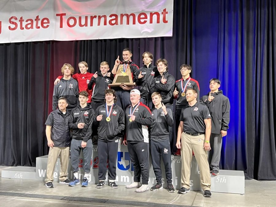 The high school wrestling team wins their first state championship. The team has had a record breaking season for the school. 