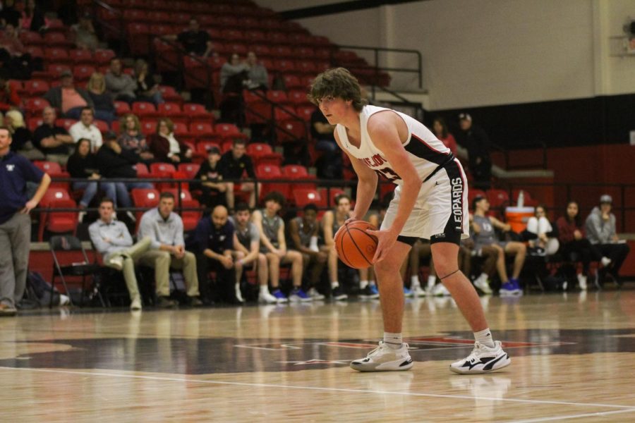 Junior power forward no. 23 Will McLaughlin looks for a pass. McLaughlin scored six points.