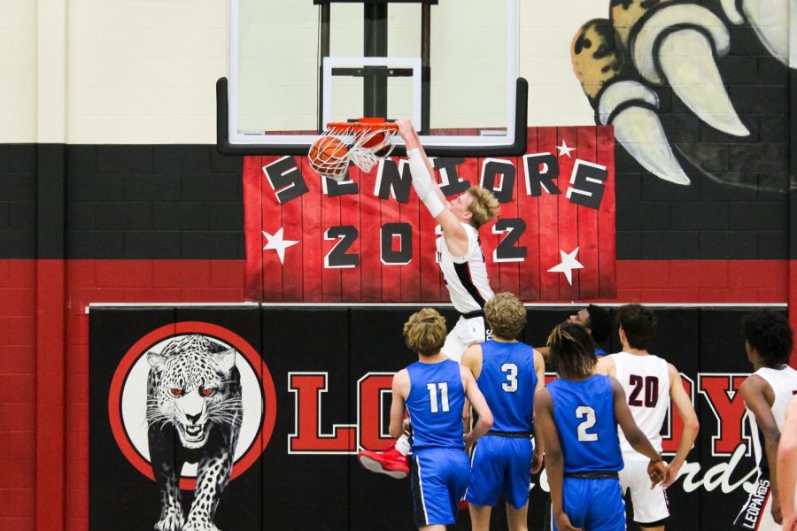 Junior power forward no. 22 Karson Templin dunks the ball. The win made the Leopards the district champion.