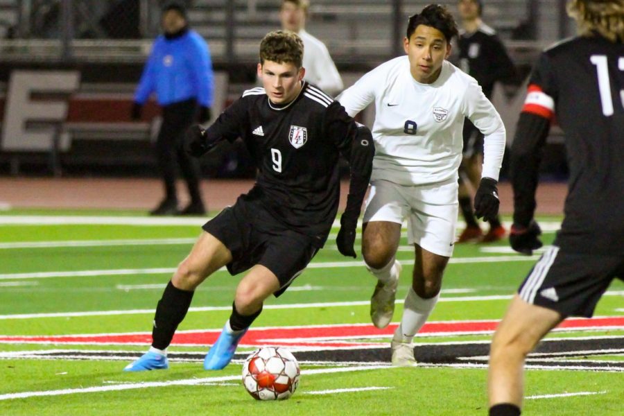 Junior no. 9 Adam Greenwald moves in front of the defender and goes for the ball. The Leopards are 8-8-1 overall.