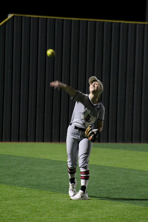 Sophomore outfielder no. 17 Kennadi Deboer throws the ball during a pre-inning
warm-up. The Leopards concluded the game with a score of 10-5.