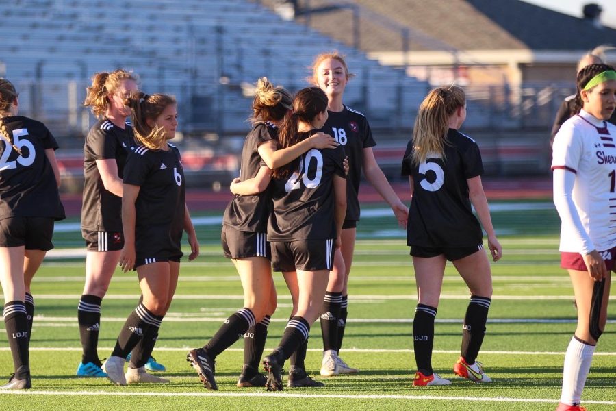 Senior forward no. 8 Maya Hignite hugs freshman forward no. 20 Emma Nelson in celebration of Nelsons goal. The team beat their overall record this season and will start playoff play this week.