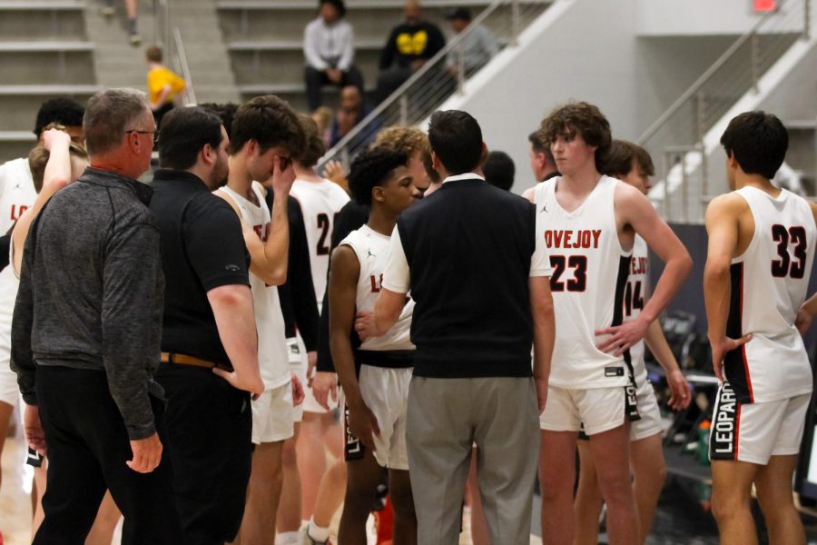 Head coach Kyle Herrema talks to the team after their loss. The Leopards lost 66-53.