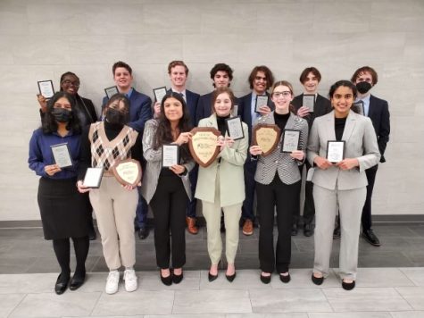 The Nationals Qualifiers stand with the plaques. The debate team will be competing in Louisville, Kentucky. 
