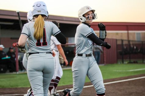 Sophomore short stop no. 11 Skylar Rucker and junior second basemen no. 11 Hannah Harvey celebrate Ruckers run. The Leopards were up 12-0 at the end of the third inning.