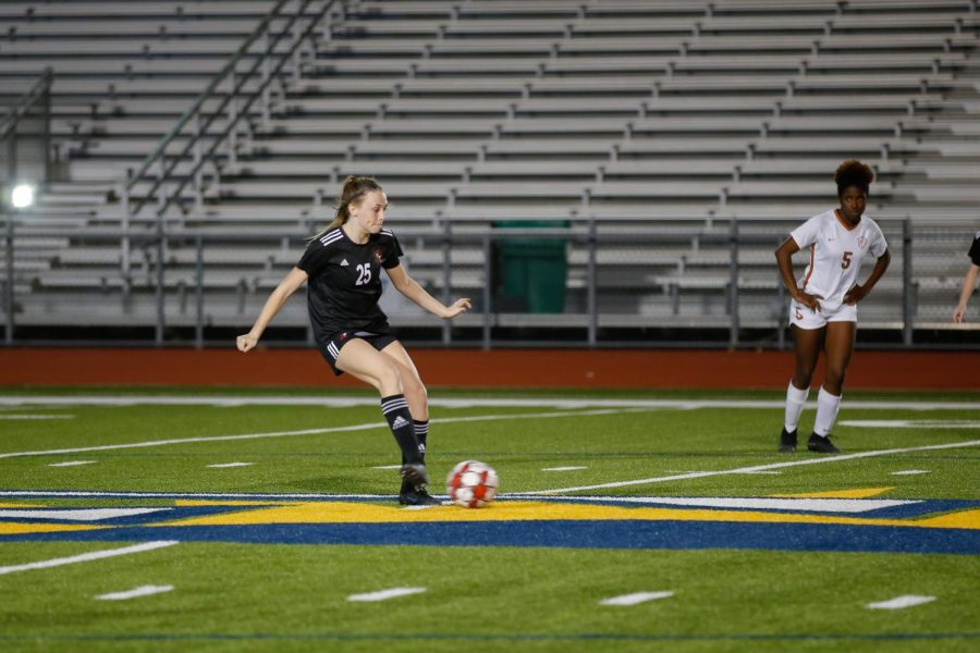 Freshman forward no. 25 Mia Reaugh passes the ball. The girls finished their season 12-2 in district.
