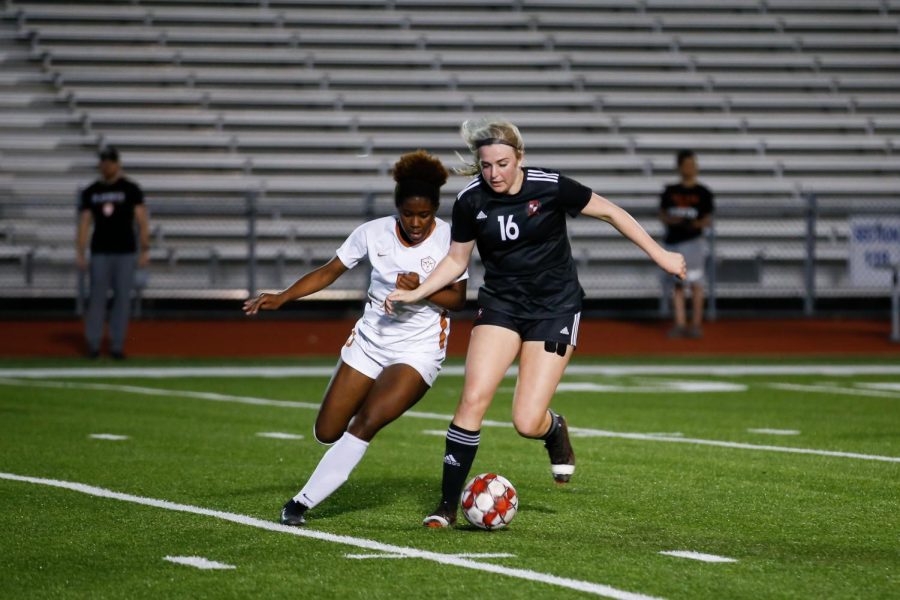 Junior left inside defender no. 16 Emmy Wood fights a Longhorn forward for the ball. The game resulted in a 1-0 loss for the Leopards.
