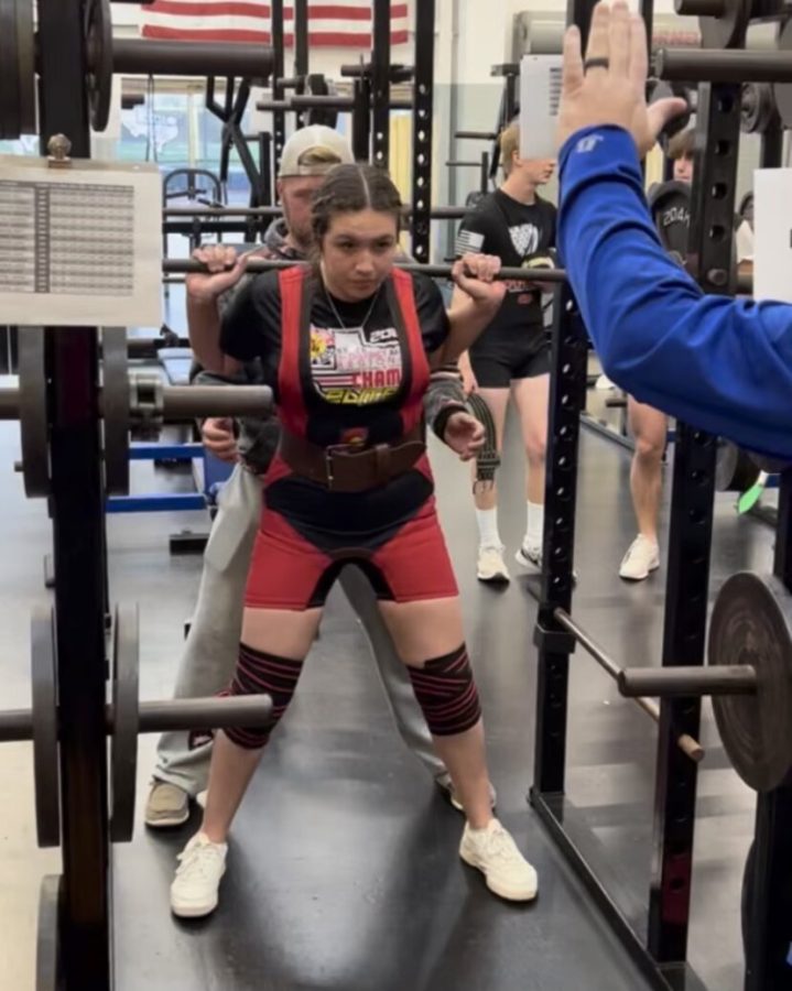 Junior Monica Bonilla power lifts during an off-season workout. Bonilla is also a member of the varsity softball team and has power lifted since her freshman year.