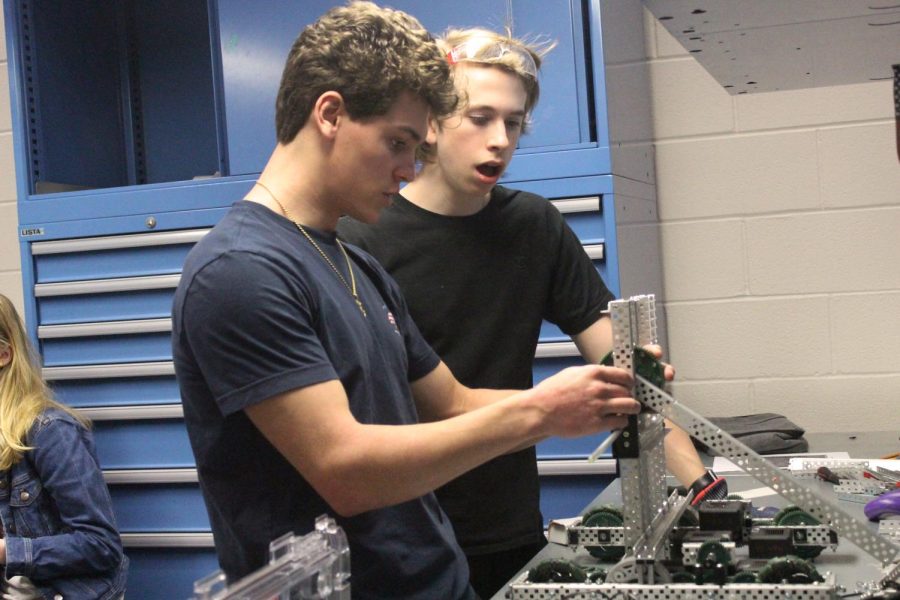 Junior Alex Tranchina and sophomore Jacob Keane adjust their robot before the UIL Worlds competition in Dallas. The competition is going to take place on May 5 through 11.