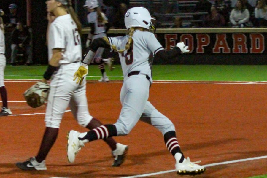 Junior catcher no. 3 Sydney Bardwell runs through third base, and heads to the home plate. Bardwell scored the sixth run for the Leopards.
