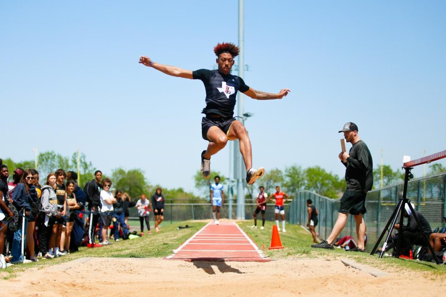 Senior Jayden Lawton jumps in the long jump. Lawton advanced to finals in both long jump and high jump. 