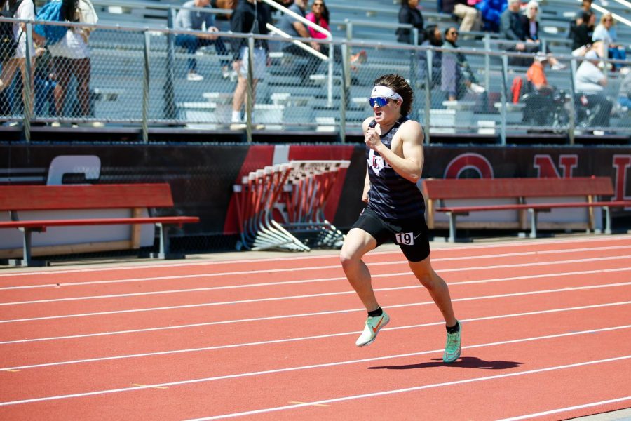 Senior Riley McGowan runs in the 400 meter dash. McGowan placed fourth running the race in 49.55 seconds.