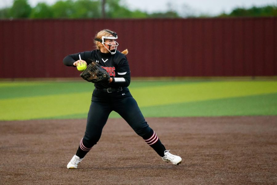 Senior third baseman no. 16 Emma Bittlestone throws the ball into junior pitcher no. 7 Jade Owens. Owens is committed to East Texas Baptist University. 