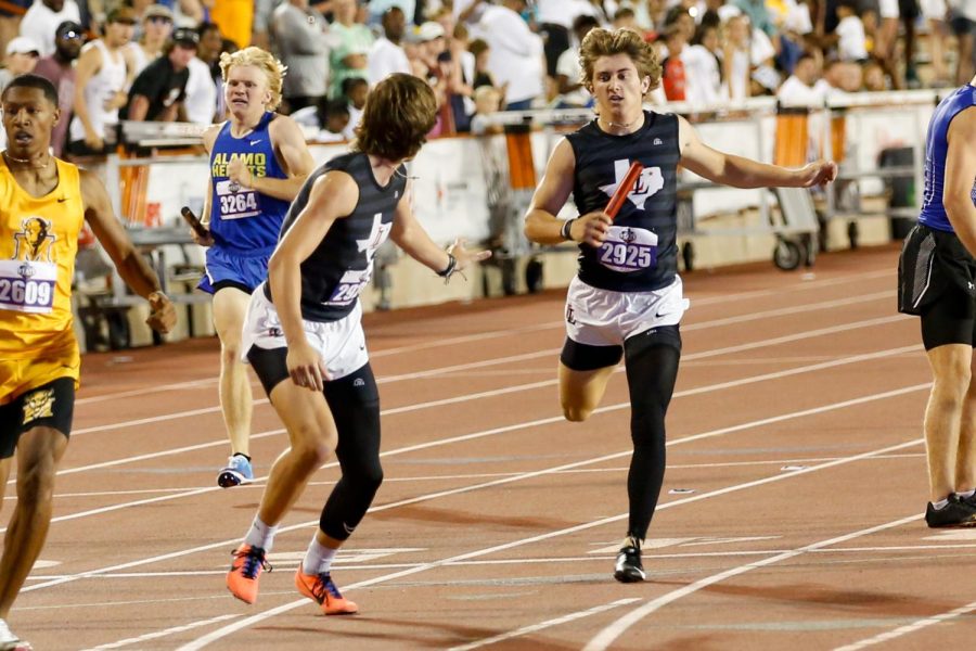 Junior Jaxson Lavender hands the baton to sophomore Parker Livingstone in the 4x400 meter relay. Livingstone ran the second leg for the team.