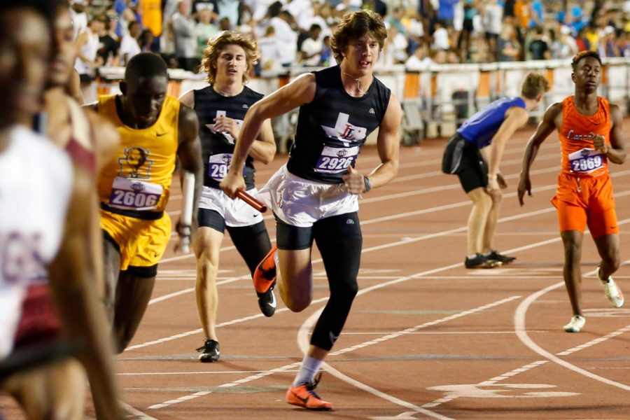 Sophomore Parker Livingstone runs the 4x400 meter relay. The relay finished third, earning a spot on the podium.