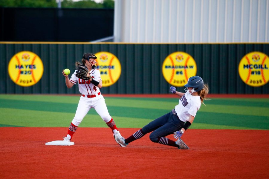 Freshman second baseman no. 4 Addie George gets a Coyote runner out. The score at the end of the first inning was 1-0. 