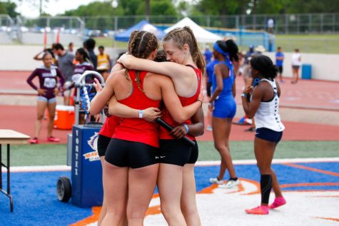 The 4x200 meter relay team celebrates after qualifying for finals. The team includes junior Chloe Schaeffer, freshman Mia Reaugh, sophomore Lauren Dolberry, and junior Leila Ngapout. 