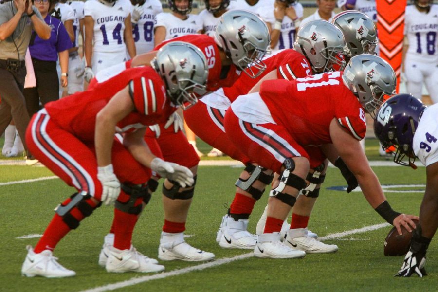 Junior offensive lineman no. 61 Sam Reynolds snaps the ball to begin the play. The offense scored seven touchdowns.