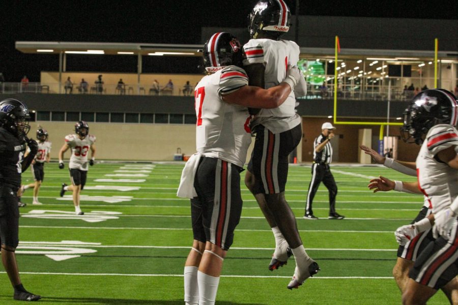 Senior wide receiver no. 1 Kyle Parker and Senior tight end no. 87 West Wilson celebrate after Parker scores a touchdown. Wilson throws on the track team.