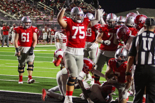 Senior left tackle no. 75 Noah Gardner celebrates a touchdown. The football team will face off against Denison this Friday.