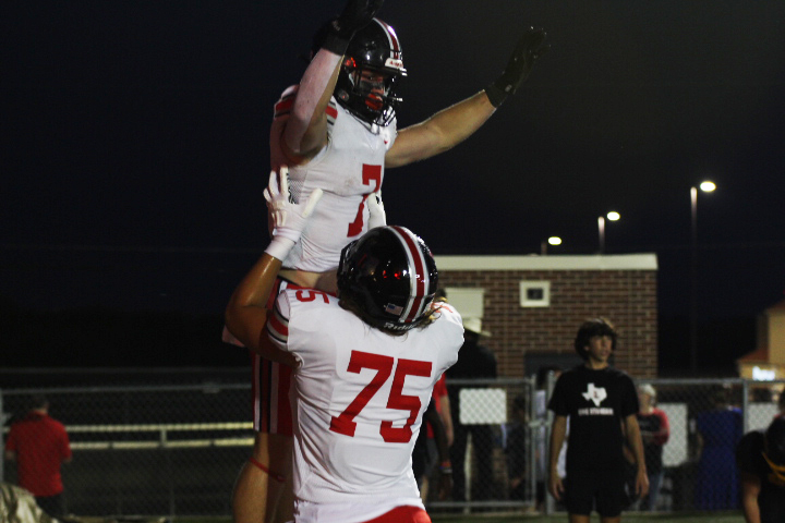 Senior left tackle no. 75 Noah Garder lifts Junior running back no. 7 Matthew Mainord into the air to celebrate a Leopard touchdown. Gardner plans to continue his football career at Tulane University.