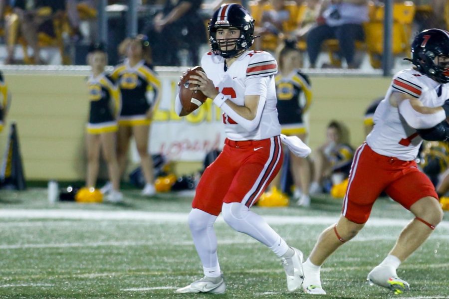 Senior quarterback no. 16 Brayden Hagle looks to throw the ball. The pass was complete to senior wide receiver no. 2 Jaxson Lavender.