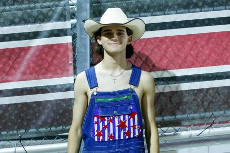 Senior Nick Spooner poses for a picture in his decked-out overalls. Spooner is excited to experience being apart of the dirty drumline. 