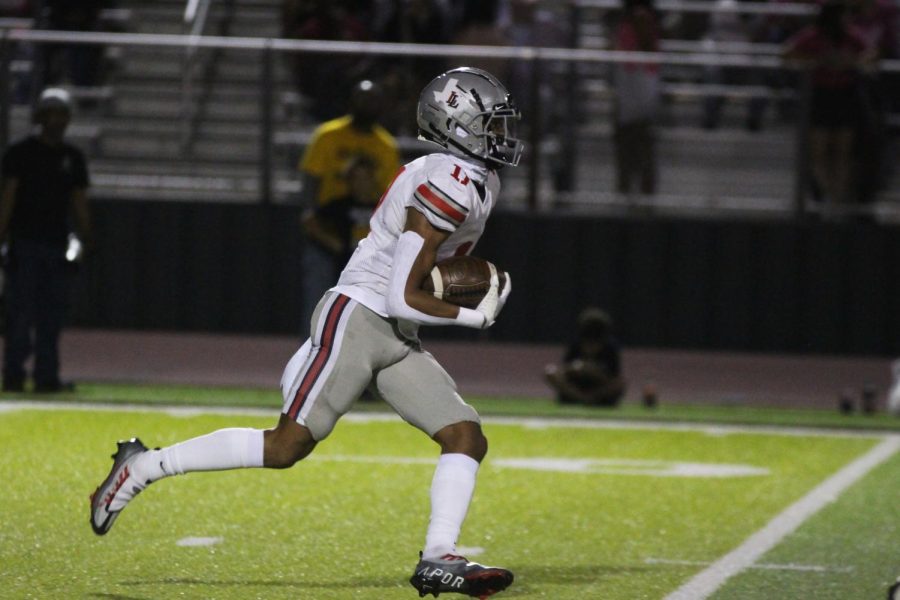 Sophomore wide receiver no. 11 Daylan Mccutcheon runs the ball. The team played against Crandall.