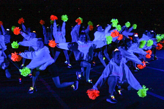 The Majestics Dance Team performs a dance  at the annual blacklight pep rally. The Majestics performed again during half time of football game against Princeton.