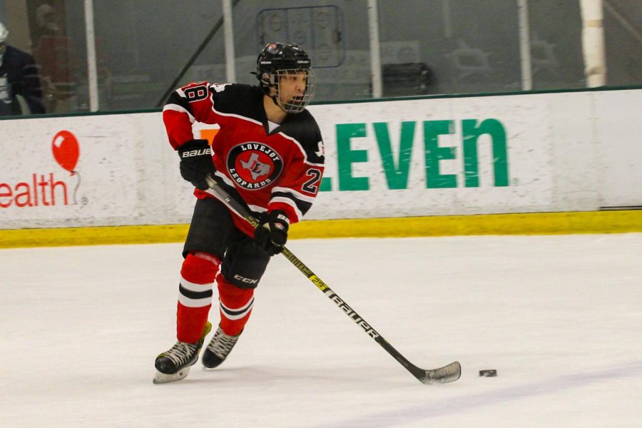 Senior no. 28 Samuel Chen moves the puck. The team is currently ranked no. 1 in the state.