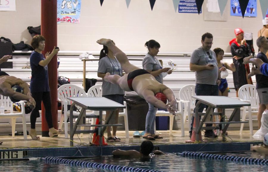 Senior swimmer Bruno Caretti dives in the pool to start the race. It was swims senior night at the Allen Tri Meet.
