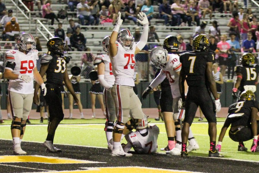 Senior right tackle no. 75 Noah Gardner raises his hands to indicate a touchdown. The touchdown was scored by Junior running back no. 7 Matthew Mainord.  