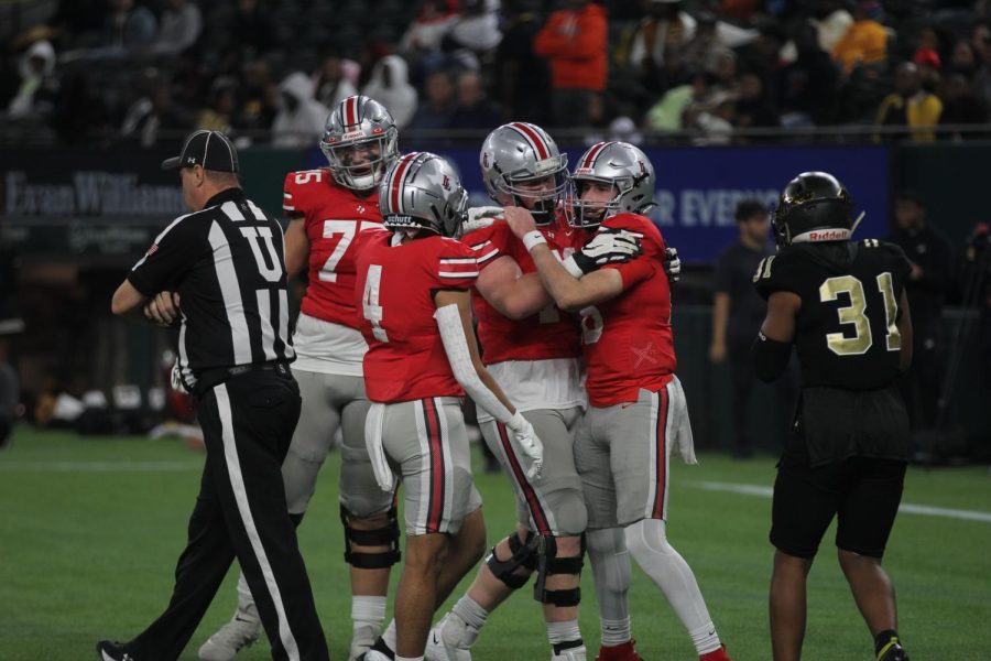 Senior quarterback no. 16 Brayden Hagle hugs senior tackle no. 70 Will fry after a touchdown. This was the teams second playoff loss to South Oak Cliff in two years.