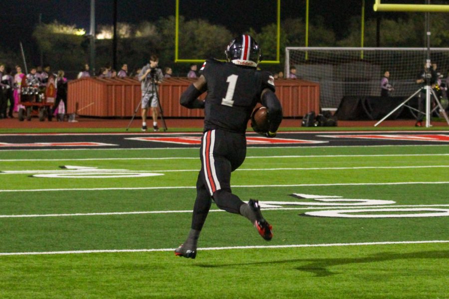 Senior wide receiver no. 1 Kyle Parker runs the ball into the end zone. The touchdown ended in a score of 21-13.