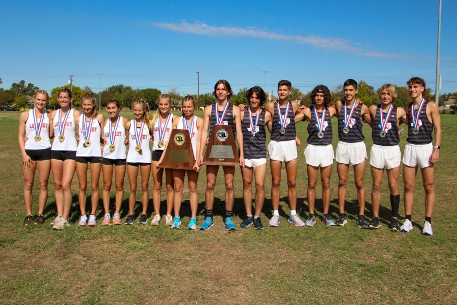 The boys and girls cross country team stand with their trophies. The girls placed first in the state, and the boys placed second.