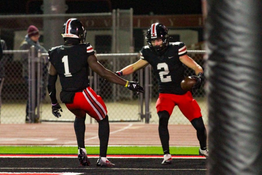 Senior no. 1 wide receiver Kyle Parker high fives senior no. 2 wide receiver no. 2 Jaxson Lavender. The team played Whitehouse in round one of playoffs. 