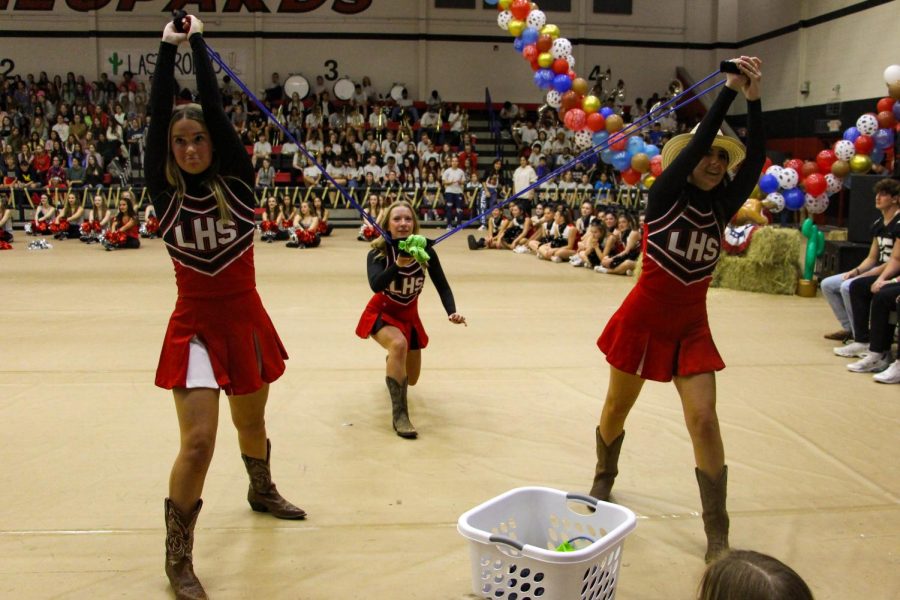 Cheerleaders launch T-shirts into the stands at the pep rally. The theme of the pep rally was western.
