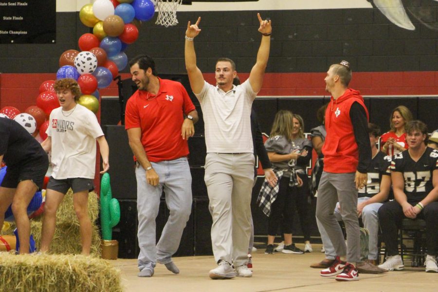 Football coach John Fee celebrates after the teachers win the pep rally competition. Fee also coaches baseball.