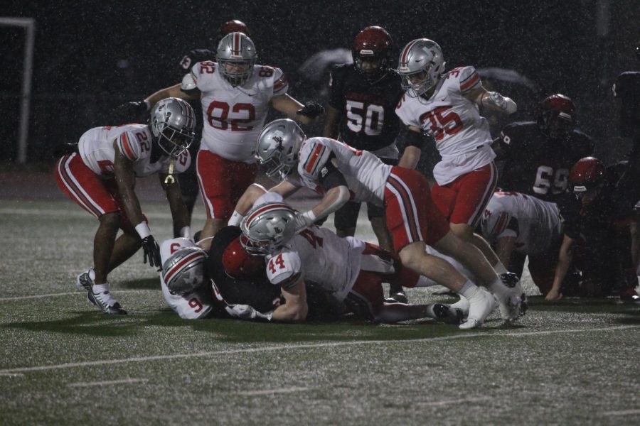 The Lovejoy defense tackles a Greenville receiver. The defense held Greenville to 13 points.