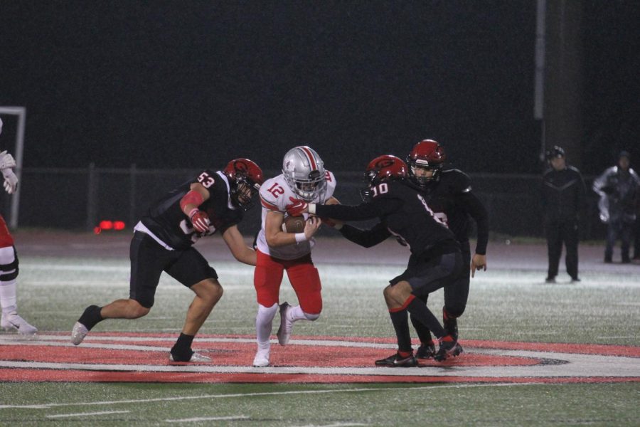 Senior wide receiver no. 12 Blake Redding runs the ball. The entire game was played in the rain. 