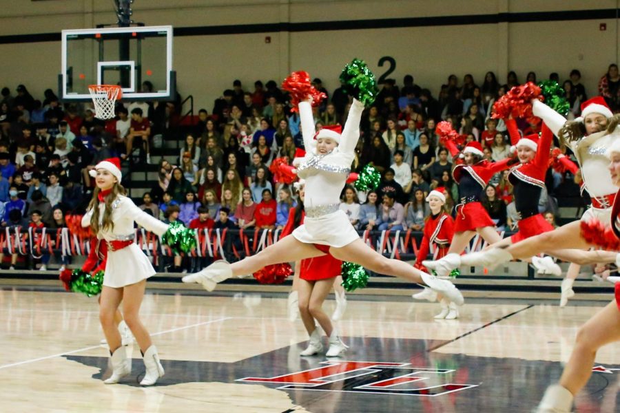 Senior Hannah Wyrick jumps during the Majestics performance at the pep rally. The pep rally also had a trivia game for each grade to compete in against each other. 