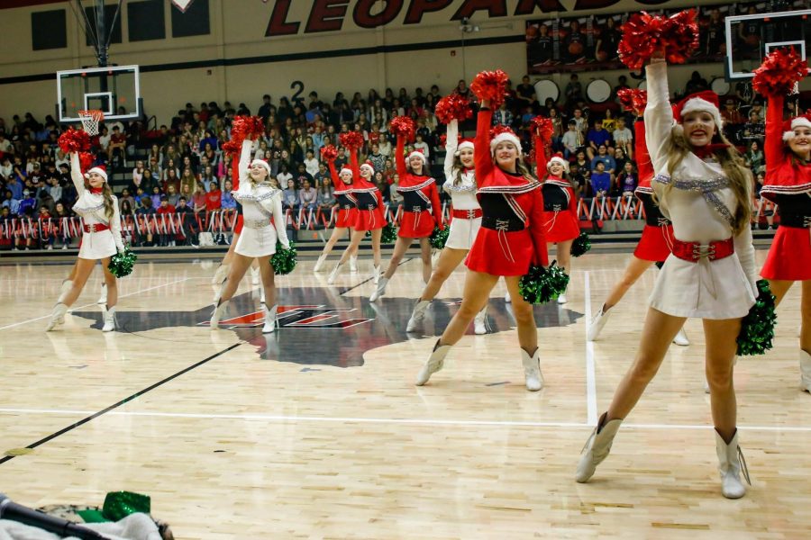 The Majestics Dance team poses during their routine. The Majestics officers are dressed in white, while everyone else dressed in red.