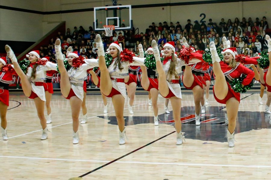 The Majestics Dance team do high kicks as a part of their dance during the pep rally. The pep rally was the last one for the semester.
