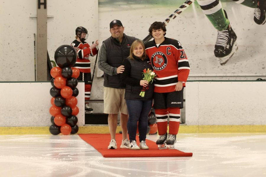 Senior no. 21 Jake Schuler Stands with his parents at senior night. Schuler is the team captain.  