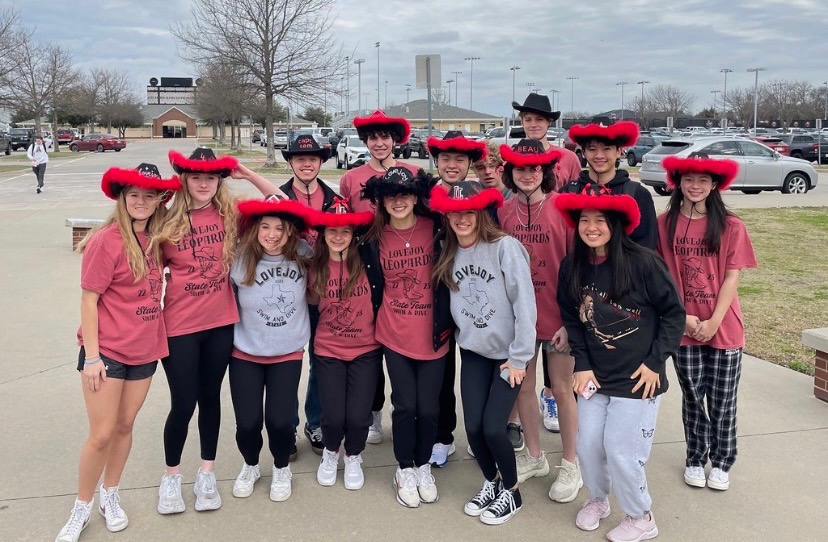 The swim and dive team poses for a picture before leaving for the state meet. 