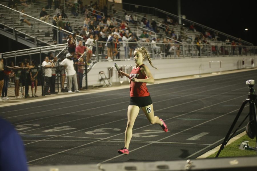 Freshman Addy McCaffity crosses the finish line of the JV girls 4x400m relay. Lovejoy got 1st with a time of 4:15.55.